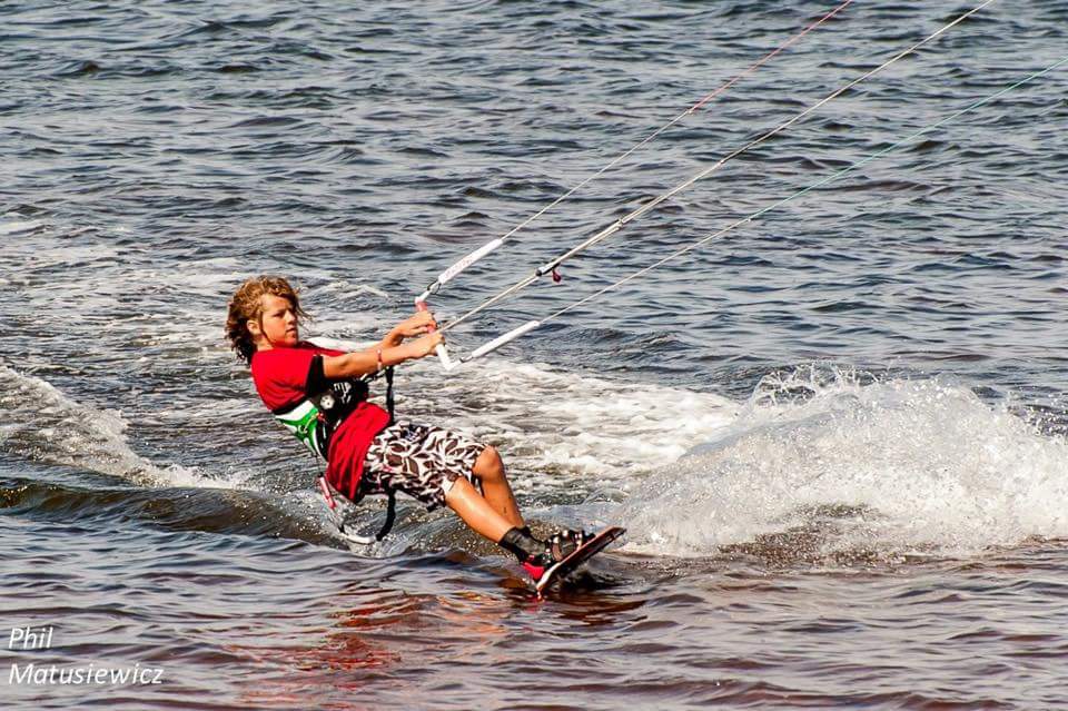 Young kiteboarder in action
