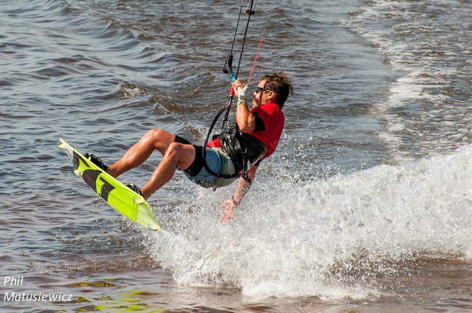 Kiteboarder in red shirt on water