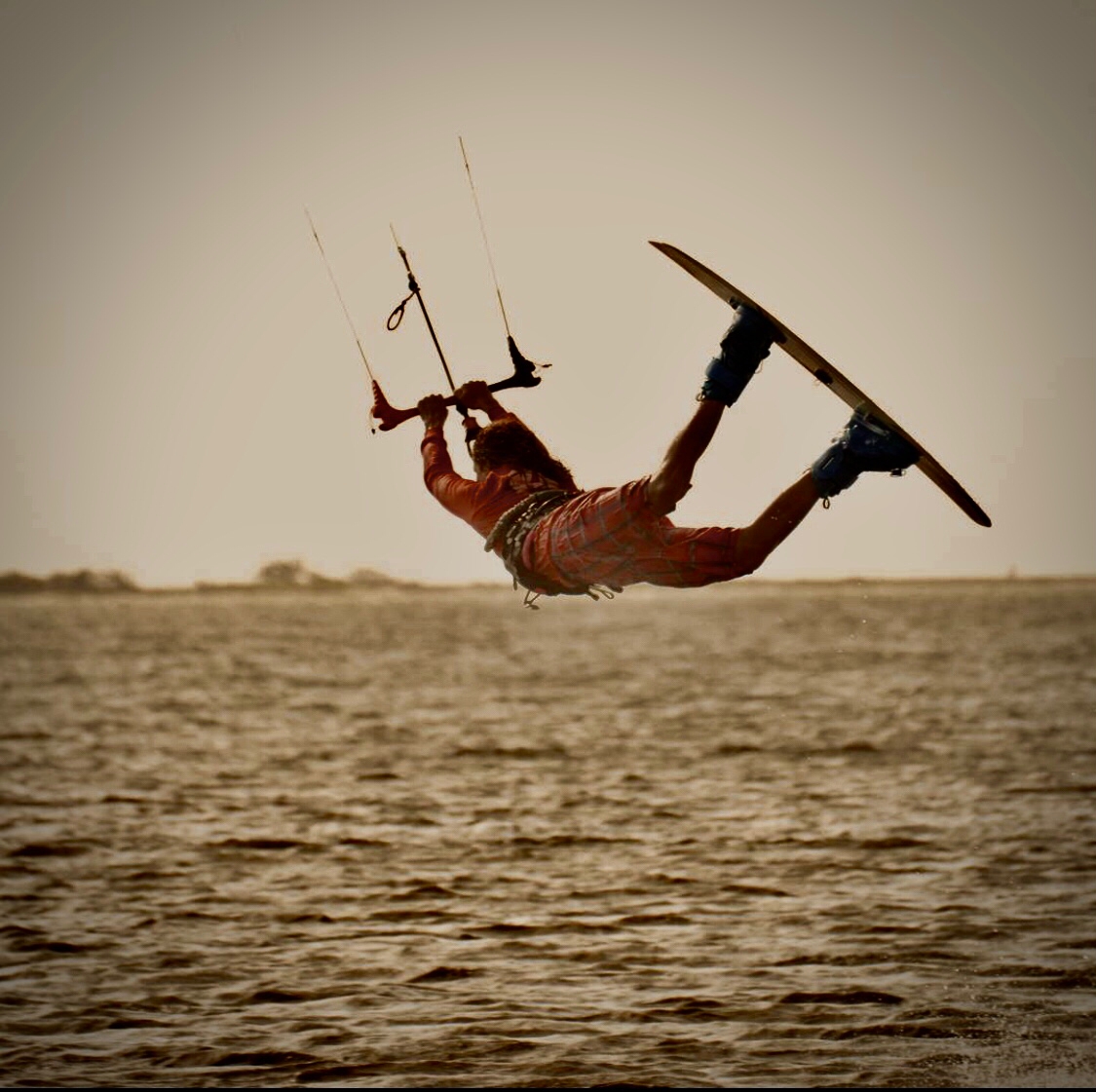 Kiteboarder performing an upside-down jump