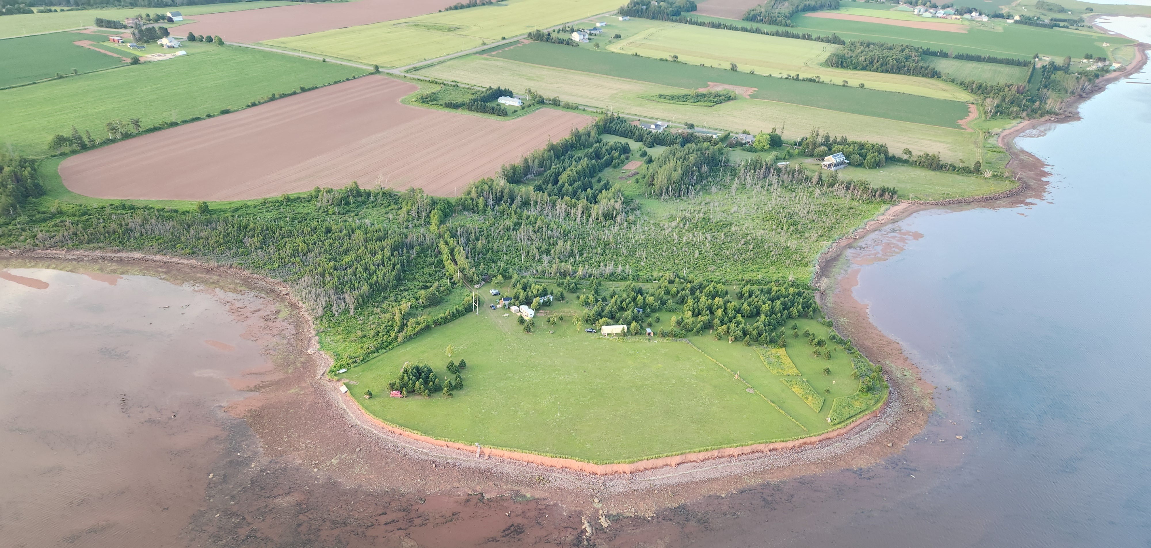 Paramotor in flight over a field